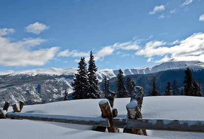 View of the mountains from a snowy hilltop in Winter Park, Colorado
