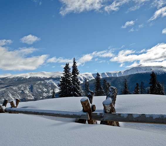 View of the mountains from a snowy hilltop in Winter Park, Colorado